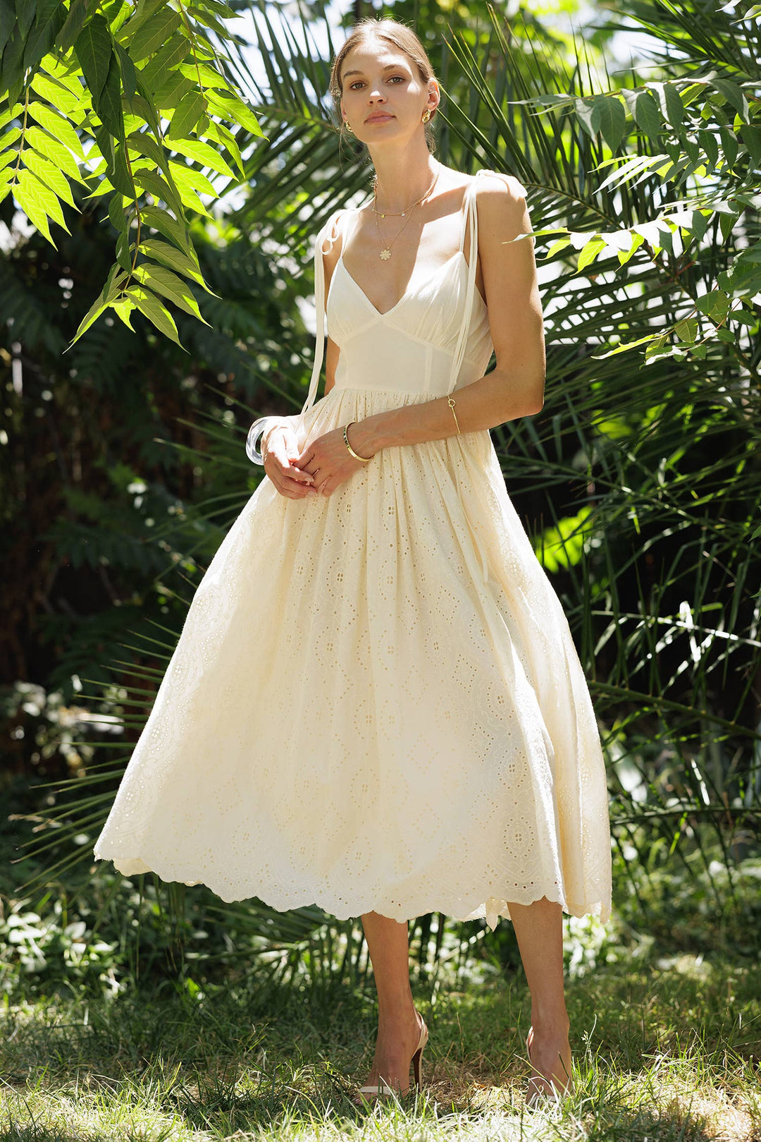 midi sun dress Eliza White Eyelet Lightweight Woven Knit Fabrication Colorful Tropical Print Sweetheart Neckline Removable Adjustable Spaghetti Straps Smocked Back Flowy Fit Ruffle Hem Maxi Length 100% Rayon Dry Clean Only Model is 54 and wearing a Small Emily Eyelet Tie-Strap Midi Sun