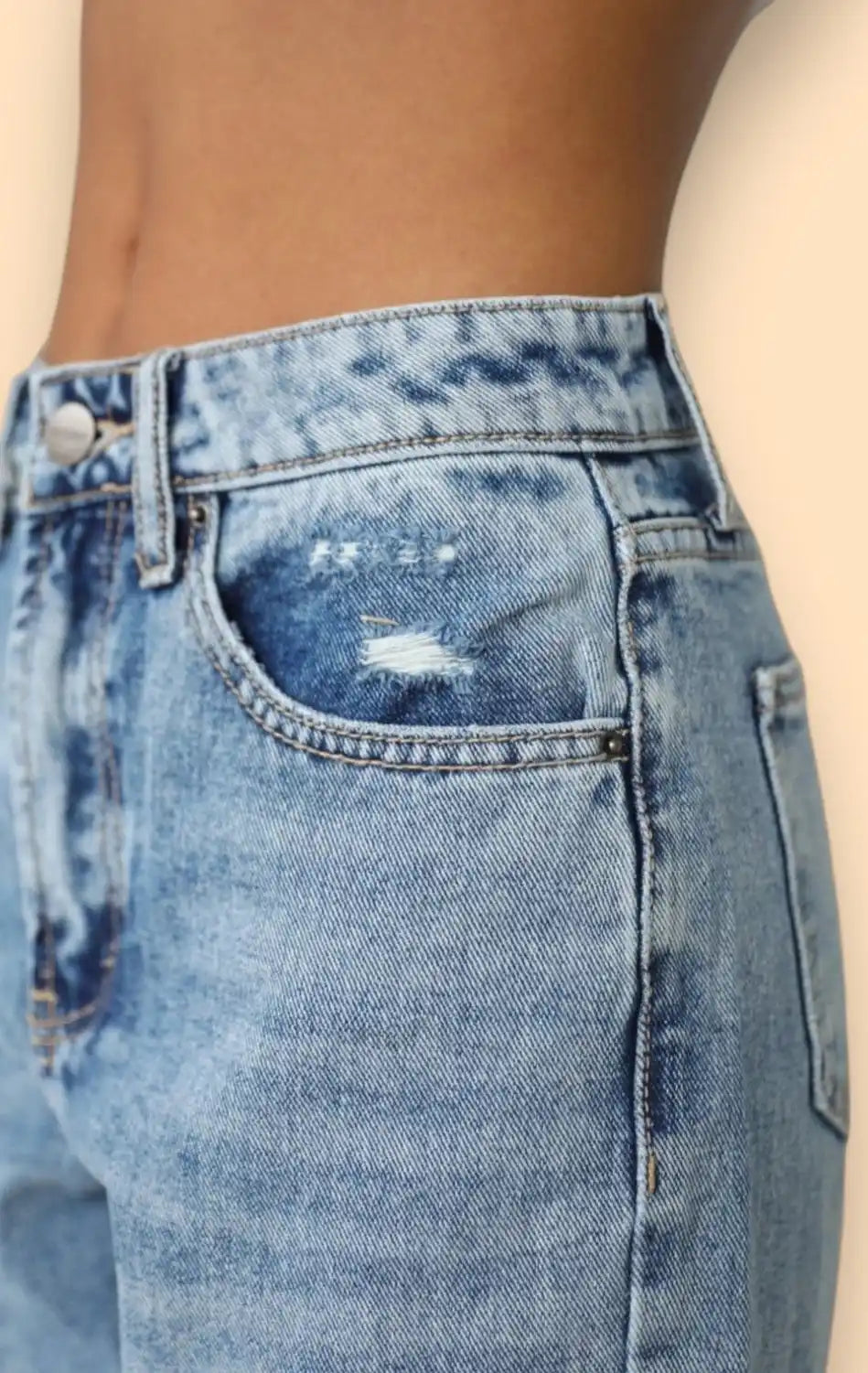 Light blue distressed denim jeans with a coin pocket.